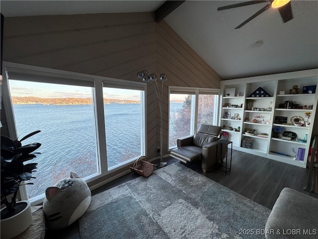 interior space featuring lofted ceiling, a water view, and a ceiling fan