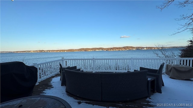 view of patio with grilling area and a deck with water view