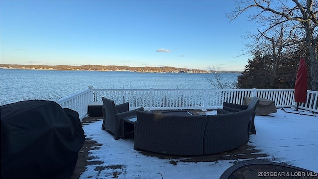 deck with a water view and area for grilling