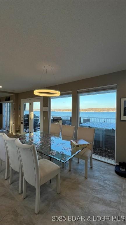 dining area with a healthy amount of sunlight and a textured ceiling