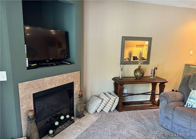 carpeted living room with a tiled fireplace