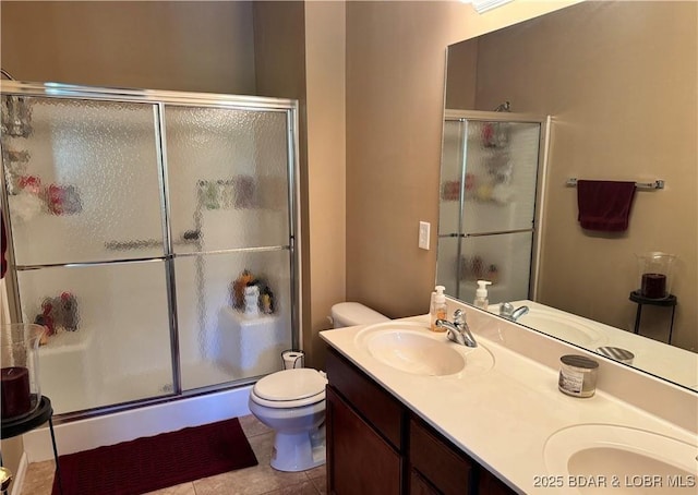 full bathroom featuring a sink, a shower stall, and double vanity