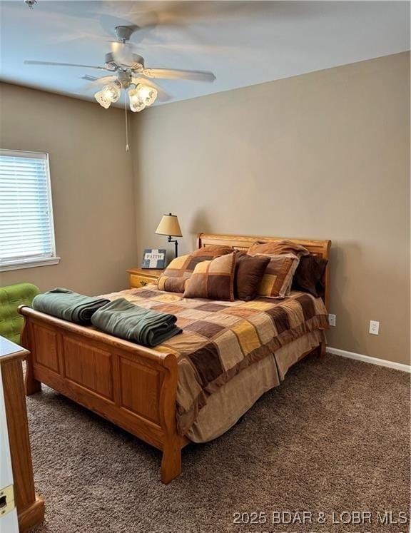 carpeted bedroom with ceiling fan and baseboards