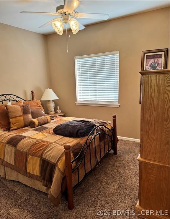 bedroom featuring carpet, baseboards, and ceiling fan