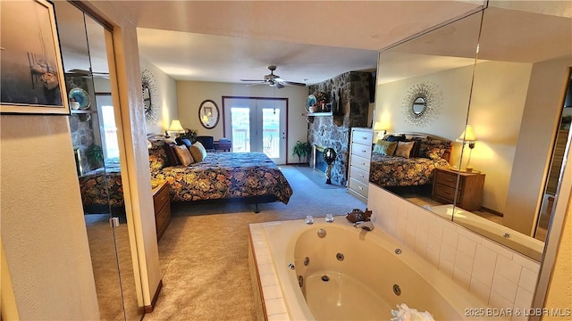 carpeted bedroom with access to exterior and a ceiling fan