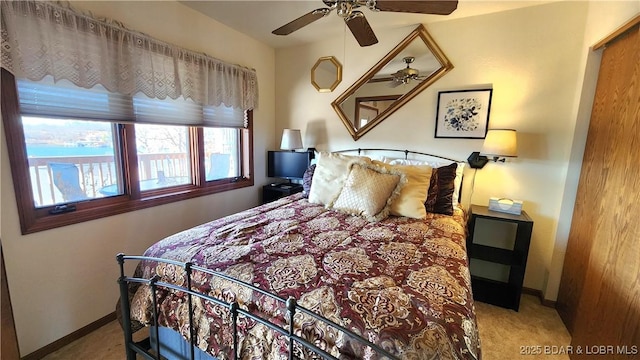 carpeted bedroom featuring ceiling fan and baseboards