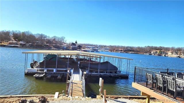 dock area with a water view and boat lift