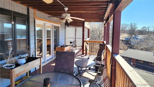 wooden deck featuring a ceiling fan and outdoor dining area