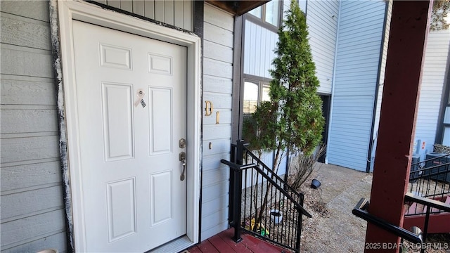 property entrance featuring board and batten siding