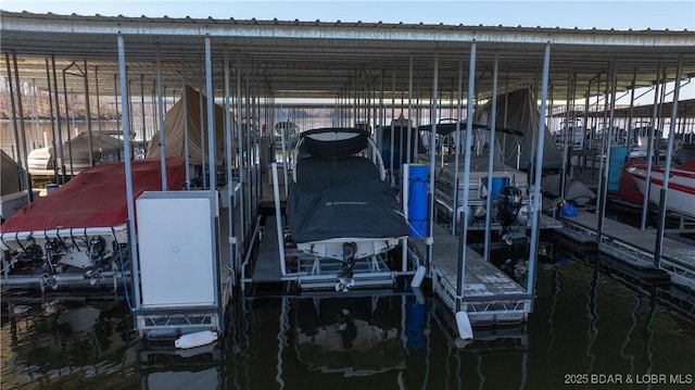 dock area with a water view and boat lift