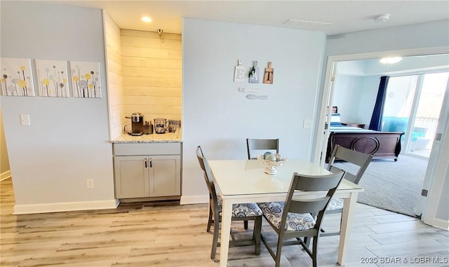 dining room with light wood finished floors and baseboards