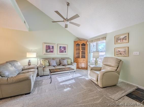 living room with baseboards, a textured ceiling, high vaulted ceiling, and a ceiling fan