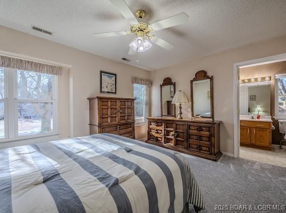 bedroom featuring light carpet, multiple windows, and visible vents