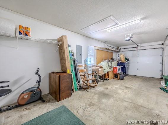 garage featuring electric panel and a garage door opener