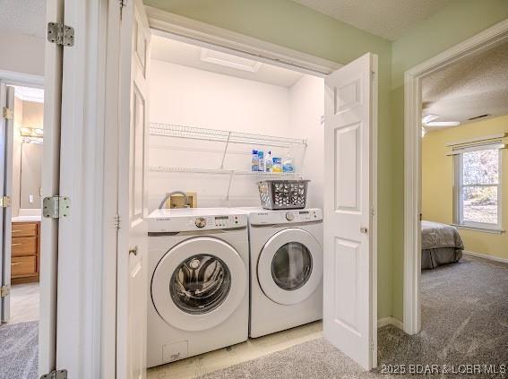 washroom featuring laundry area, baseboards, light colored carpet, and independent washer and dryer