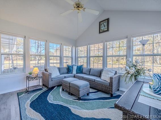 sunroom featuring a ceiling fan and lofted ceiling