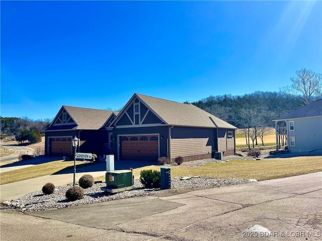 view of front of home with driveway, a front lawn, and an attached garage