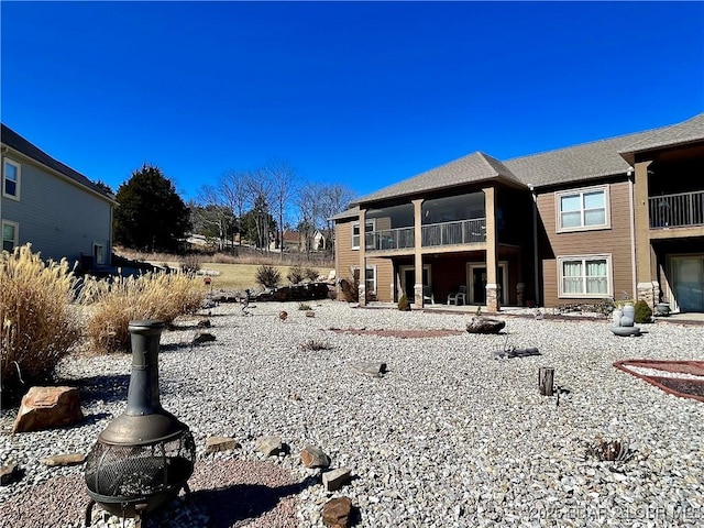 rear view of property featuring a balcony