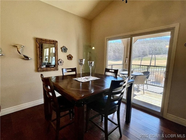 dining area featuring baseboards, vaulted ceiling, and dark wood-type flooring