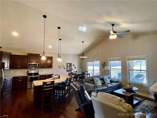 living room with dark wood-style floors, high vaulted ceiling, baseboards, and ceiling fan with notable chandelier