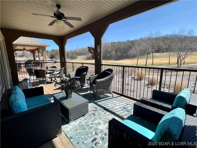 wooden deck featuring ceiling fan and an outdoor hangout area