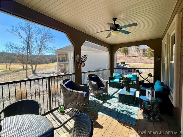 deck with a ceiling fan and outdoor lounge area