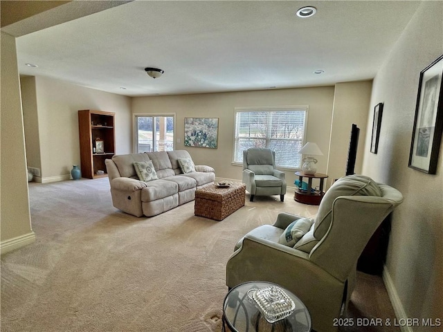 carpeted living room featuring a wealth of natural light and baseboards