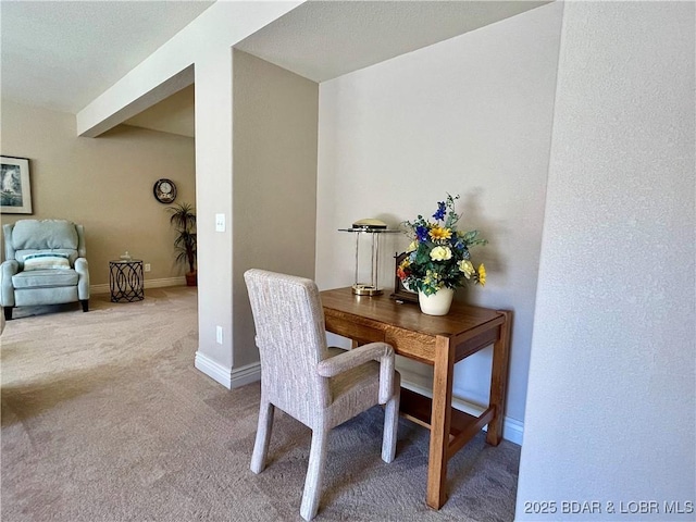 carpeted office featuring baseboards