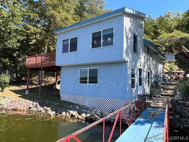 back of house with a deck