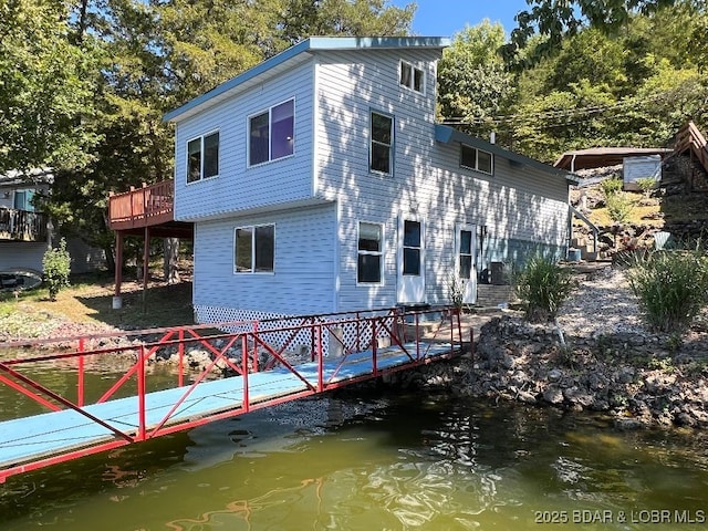 exterior space featuring a deck with water view