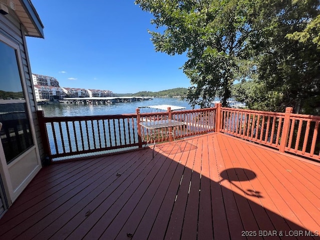 wooden terrace featuring a water view