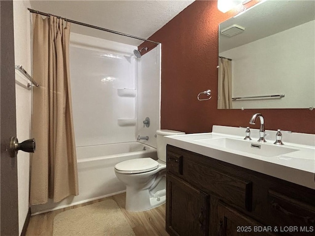 bathroom featuring toilet, wood finished floors, visible vents, vanity, and shower / bath combination with curtain