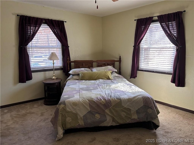 bedroom featuring carpet and baseboards