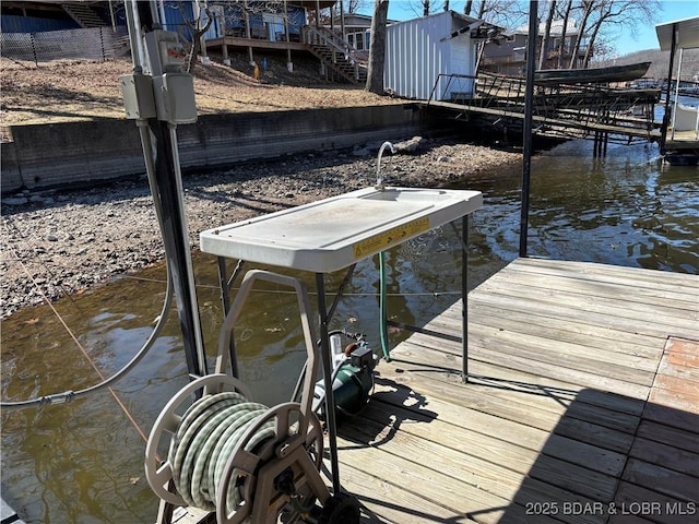 dock area featuring a water view and stairway