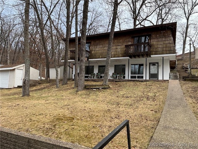 rear view of property featuring a balcony