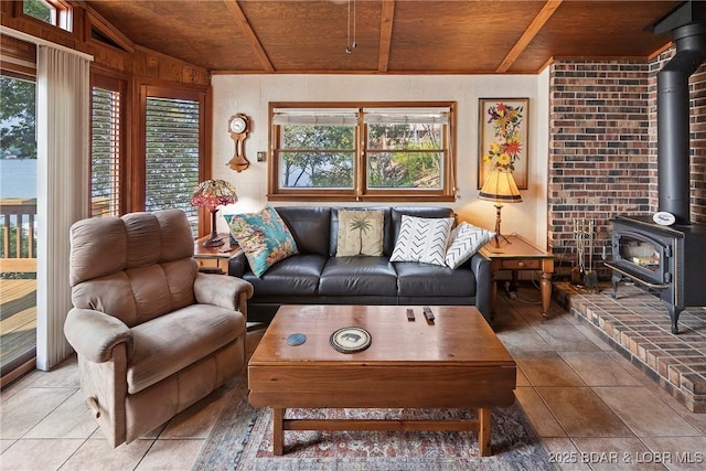 136 Rambling Acres Dr, Gravois Mills, MO 65037 - living room with wood ceiling, a wood stove, tile patterned flooring, and vaulted ceiling