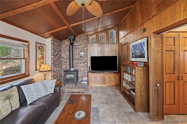 136 Rambling Acres Dr, Gravois Mills, MO 65037 - living area with lofted ceiling with beams, light tile patterned flooring, wooden ceiling, and a wood stove