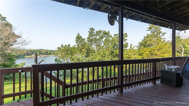 wooden terrace featuring a water view