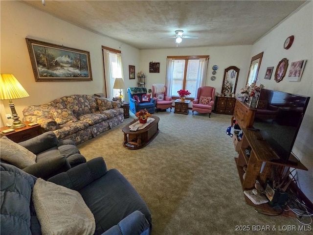 living room featuring ceiling fan and carpet