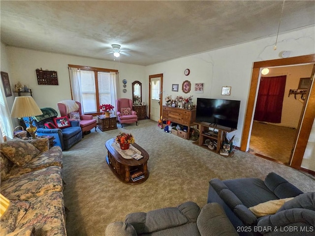 carpeted living room with a textured ceiling and a ceiling fan