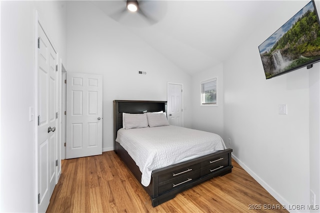 bedroom featuring light wood-type flooring, ceiling fan, visible vents, and baseboards