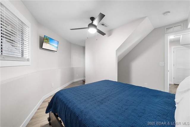 bedroom with visible vents, ceiling fan, baseboards, and wood finished floors