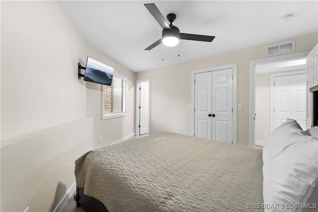 bedroom featuring a closet, carpet, visible vents, and a ceiling fan