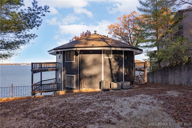 view of outbuilding with a water view and fence