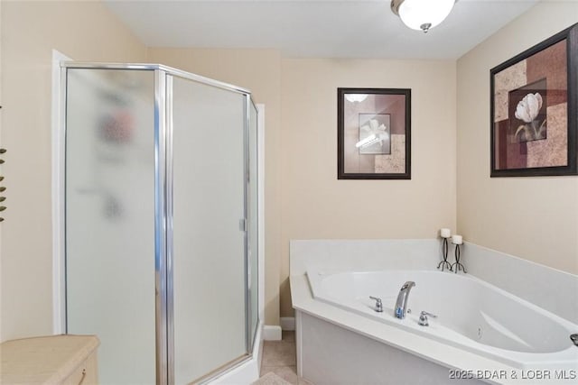 bathroom featuring a tub with jets and a stall shower