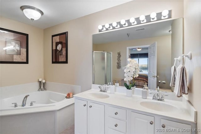 full bathroom with double vanity, a shower stall, a garden tub, toilet, and connected bathroom
