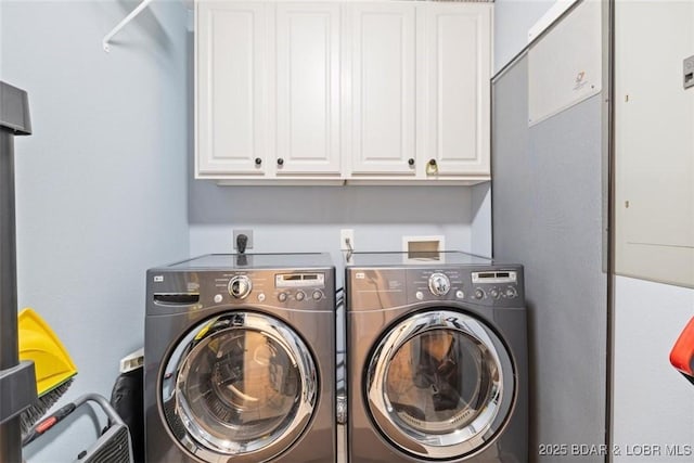 laundry area featuring washer and dryer and cabinet space