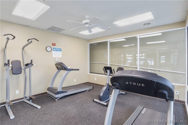 gym featuring a ceiling fan and baseboards