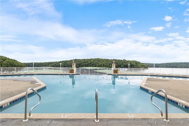 community pool featuring fence