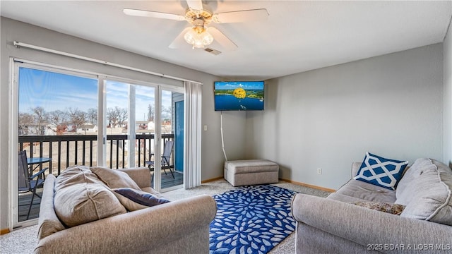 living room featuring carpet floors, visible vents, ceiling fan, and baseboards